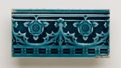 Tile with floral border pattern